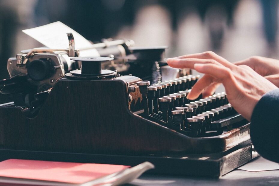 hands type on a typewriter